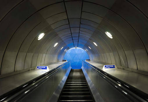 The escalator connects the underground of Southwark Station to the entrance hall. You can see the blue decor of the architecture as you come up from below.