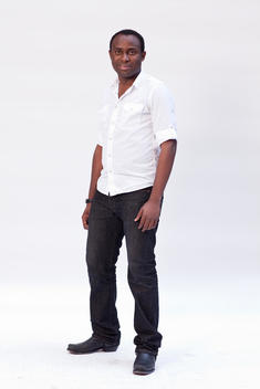 African Or African-American Man 30-40 Years Old In White Shirt And Black Jeans And Boots, Full-Body Studio Portrait On White Background