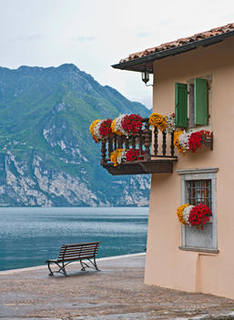 House with window box flowers next to Lake Garda, Torbole, Trentino, Italy