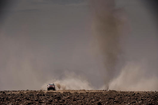 Dakar rally car dust and little twister