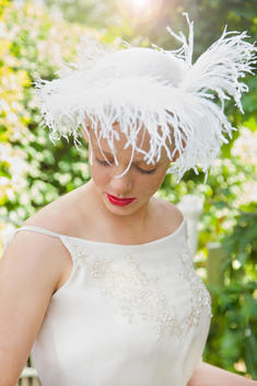 Young Woman Wearing Hat with Feathers Outdoors