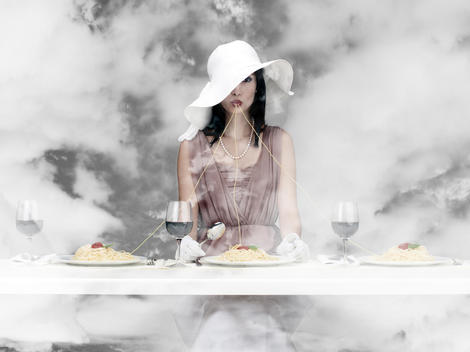 Pasta Light _ Well-dressed young woman eating spaghetti from three different plates