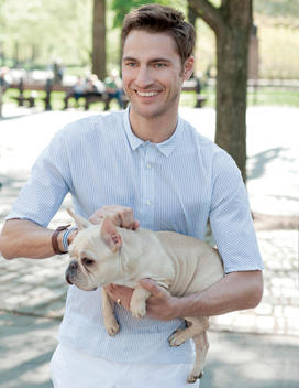 Man Holding French Bulldog And Laughing
