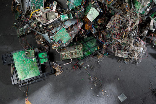 A towering pile of recyclable electronic items at a plant