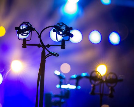 Crowd microphones and stands at a concert.
