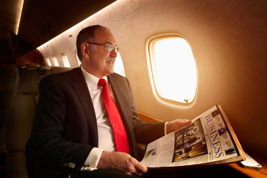 Caucasian businessman flying on private jet