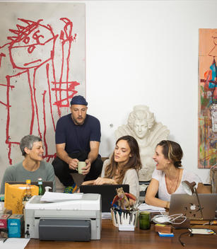 Art dealer, Stefan Simchowitz watches his two female assistants work in his office surrounded by works of art