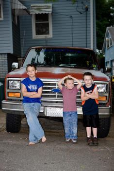 Young Brothers Nonchalantly And Casually Pose In Front Of Truck