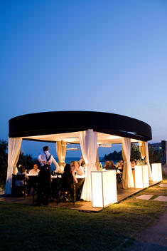 Waiter Serving Diners In Outdoor Dining Area
