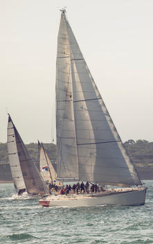 Sailing yacht in full sails racing.