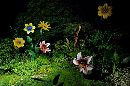 At nightfall, large fantastical ceramic flowers illuminate the jungle slopes of Singapore?s man-made resort island, Sentosa, which draws five million visitors a year.