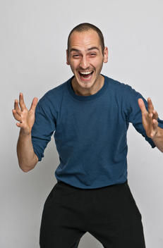 ecstatic male in his late 20s, expression of happy surprise