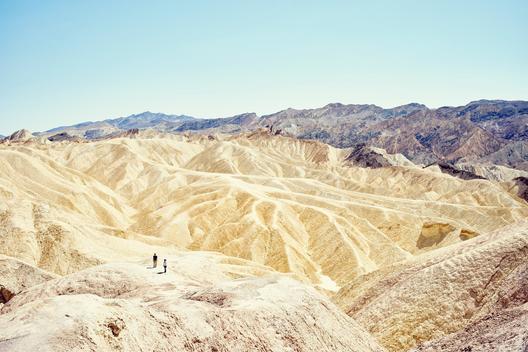 View of two tourists at Zabriskie Point, Death Valley, California, USA