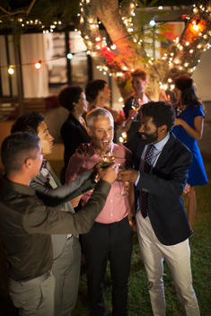 Men toasting each other at party