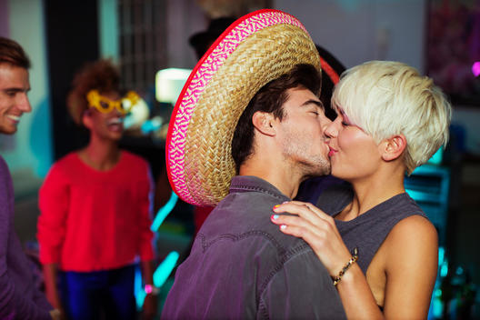 Couple kissing at party