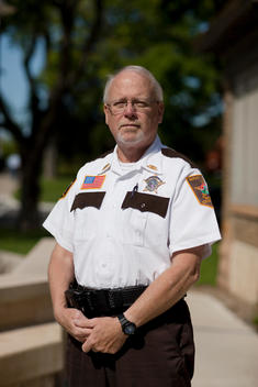 A Rice County Police Officer Poses For A Portrait In Front Of The Police Station In Faribault, Mn.