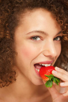 Close up of Woman Biting Strawberry