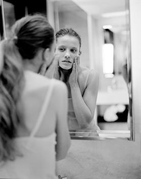 Beauty Model Looking At Self In Mirror