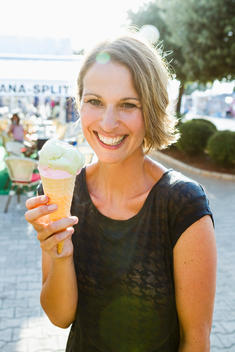 Smiling woman having ice cream cone