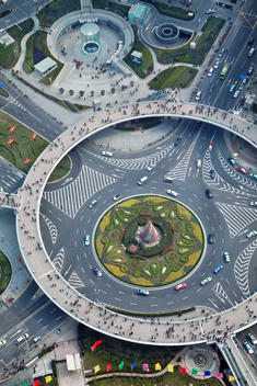 Photographed through the spherical glass floor of the Oriental Pearl Tower, an enormous roundabout functions as ornament and traffic control in the financial heart of Shanghai.