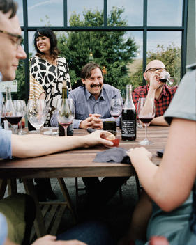 South East Wine Division Collective owners and wine makers, Tom and Kate Monroe with friends at an outdoor table
