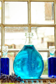 perfumes bottles on windowsill