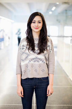 Portrait of confident female university student at college corridor