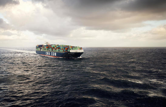 Ship Carrying A Load Of Containers Navigates Choppy Waters.