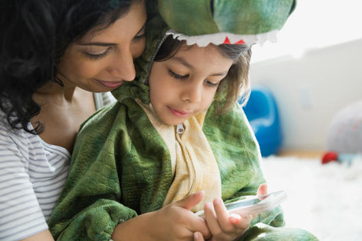 Mother holding son in dragon costume