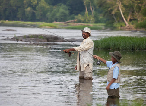 African grandfather and grandson fishing