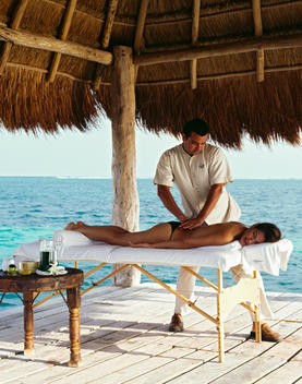 Young Woman Getting Outdoor Massage By The Ocean