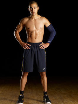 Muscular, Shirtless Man Standing With Hands On Hips On Black Background