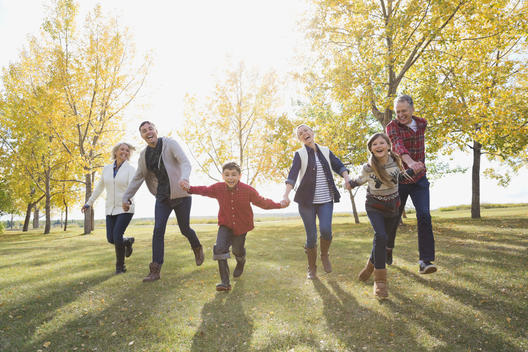 Multi-generation family running in park