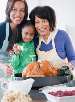 Black family preparing Thanksgiving dinner