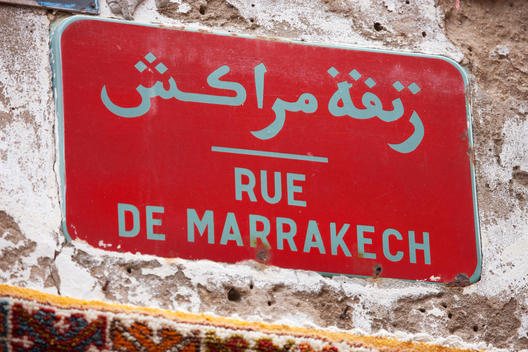 Red street sign on wall, Essaouira, Morocco