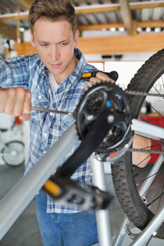 Man working on bicycle in shop