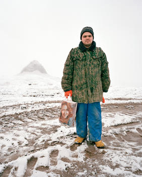 Alex Anishenko Stands In The Snow Holding A Plastic Bag At Kupol Gold Mine, Chukotka.