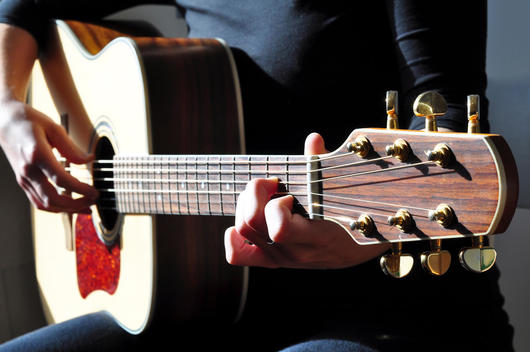 Woman playing a western guitar