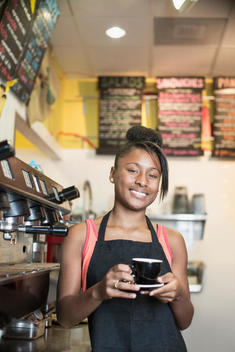 Black teenage girl working in cafe