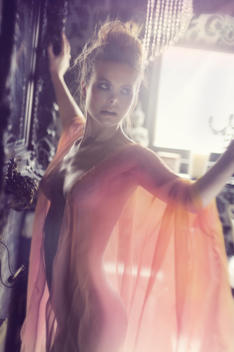 Back lit image of a naked woman wearing a see through neglige