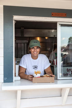 A Clam Shack employee serves a lobster roll with french fries in Kennebunk, Maine.