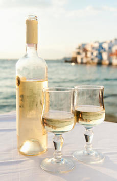 Greece, Cyclades Islands, Mykonos, Wine on table by sea