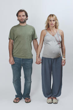 Full height portrait of a couple, woman is pregnant