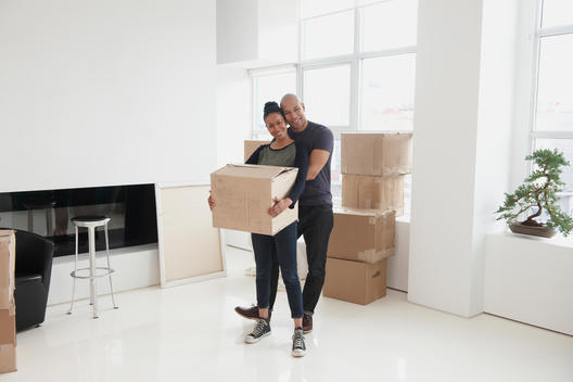 Black couple unpacking in new house