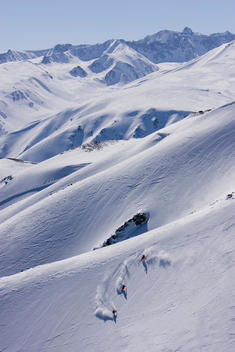 India, Kashmir, Gulmarg, Three persons skiing downhill