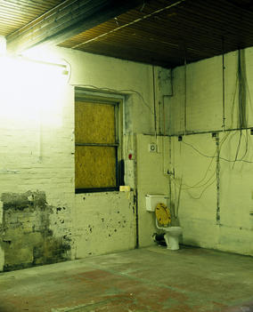 Toilet In Corner Of Dilapidated Empty Warehouse Room