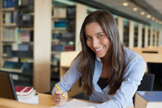 Portrait of female student studying in library