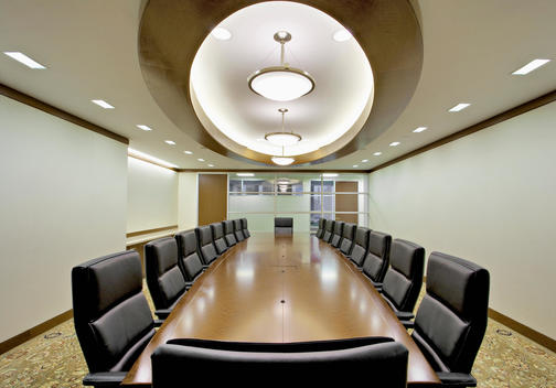 Conference Room With Fitted Oriental Carpet, Black Leather Chairs, Wood Trimmed Ceiling Fixtures