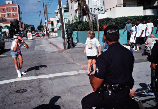 Officers pose for a photo from tourists as they also look for gangs who come to Venice Beach.