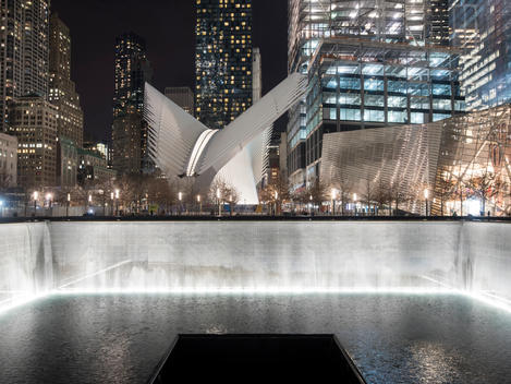 The Memorial Fountain and the Transportation Hub in illuminated in the background. World Trade Center